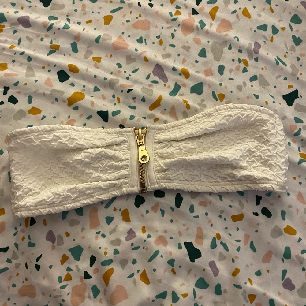 White bathing suit top with with a zipper.